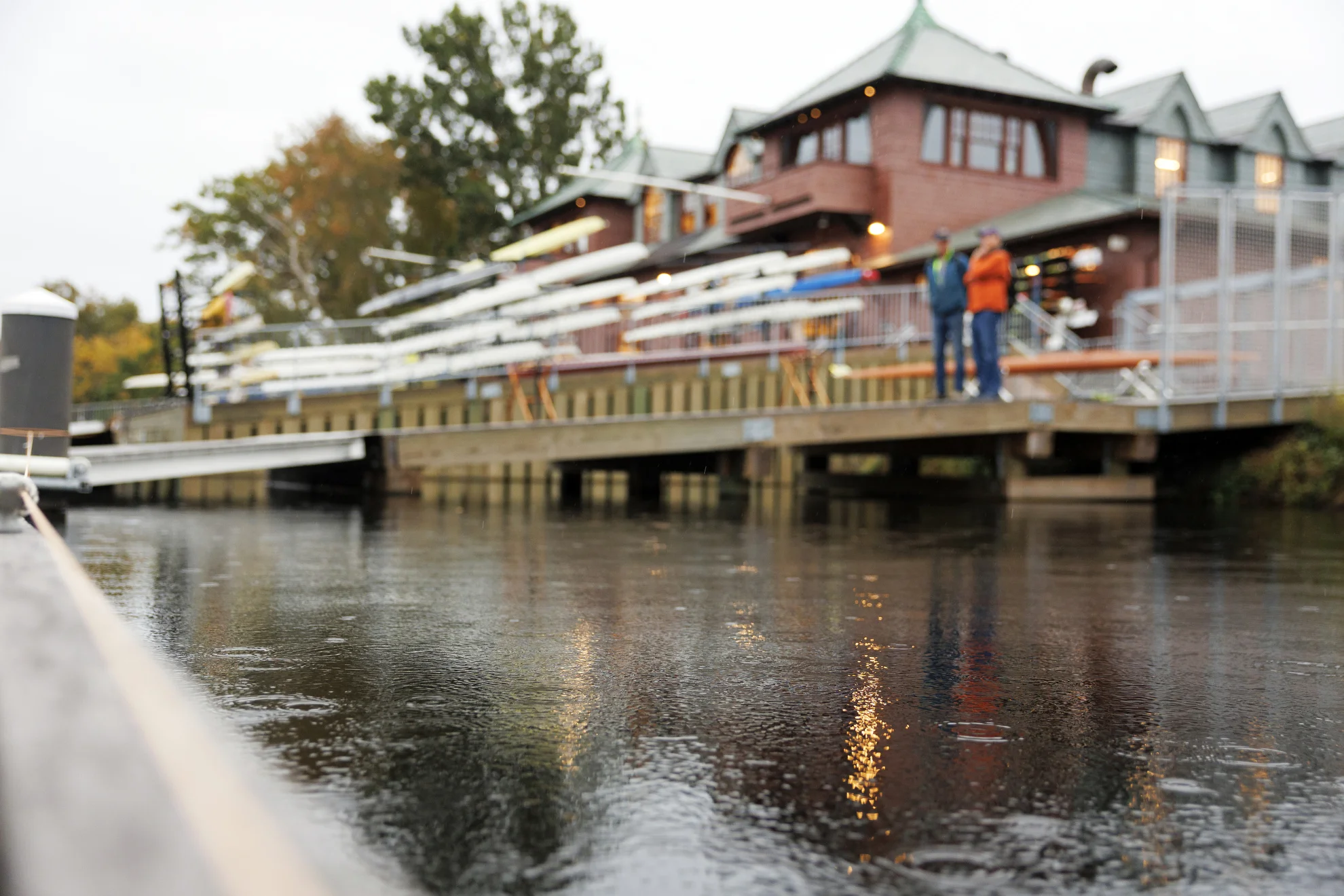 Raindrops falling on the water in front of Newell Boat House.