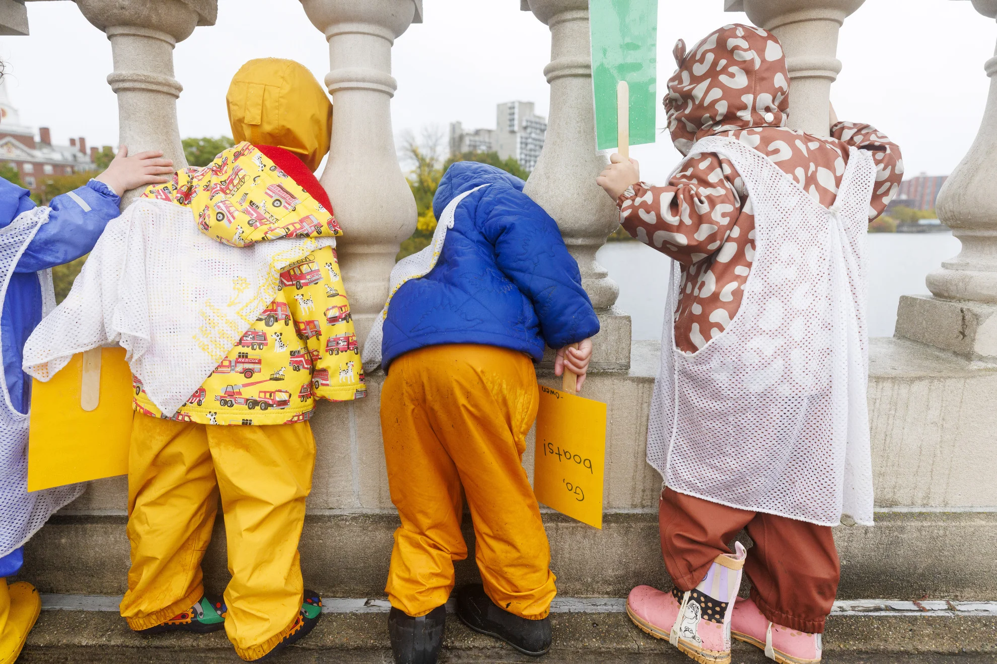 Preschoolers from the Cambridge-Ellis School cheer on rowers from the Weeks Footbridge.
