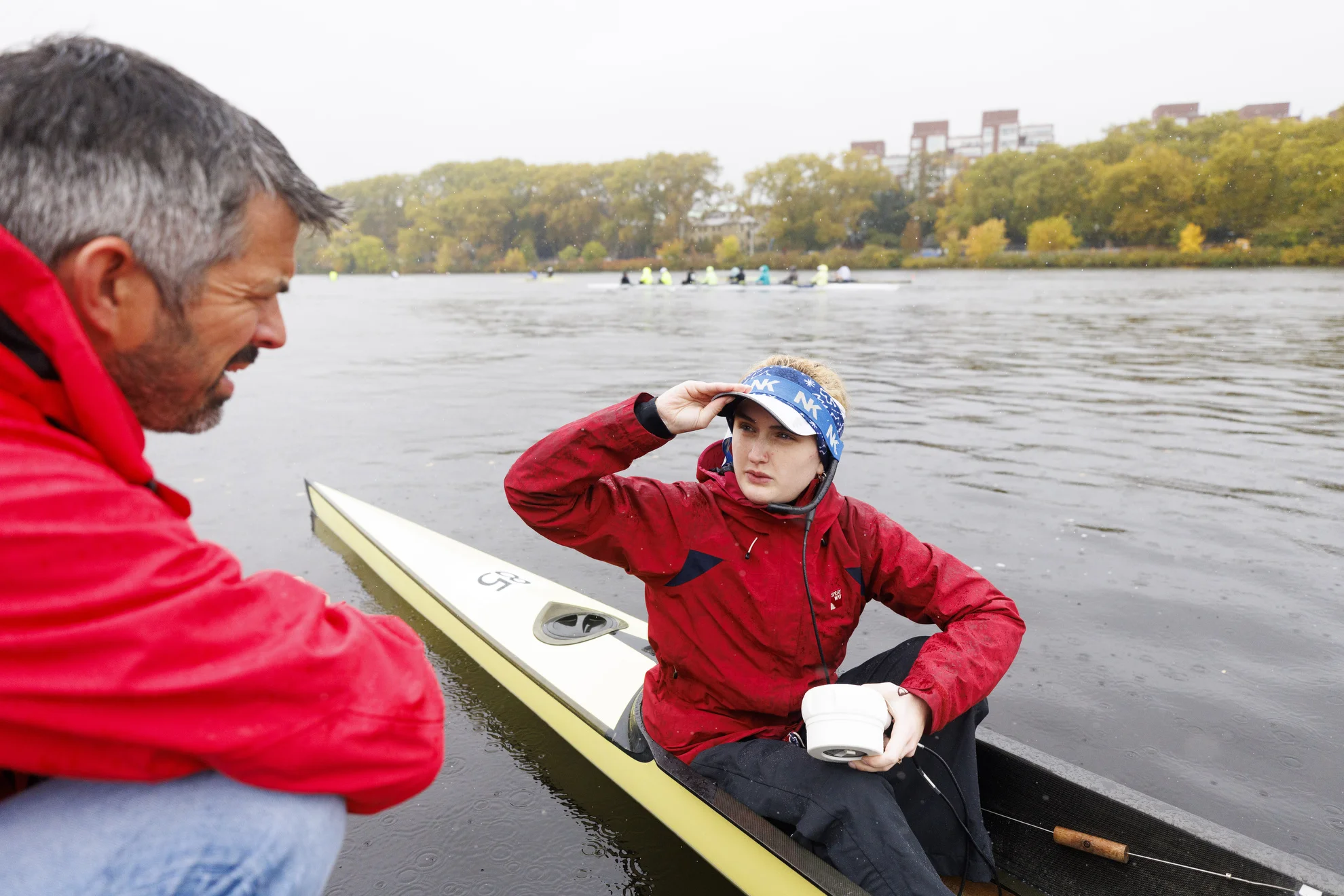 Rachel Roberts, a coxswain part of the Cork Boat Club, talks through the turns and bridges of the Charles River with teammate Patrick Duggan.