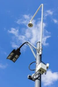 Sensors and cameras are seen attached to a high pole at an intersection.